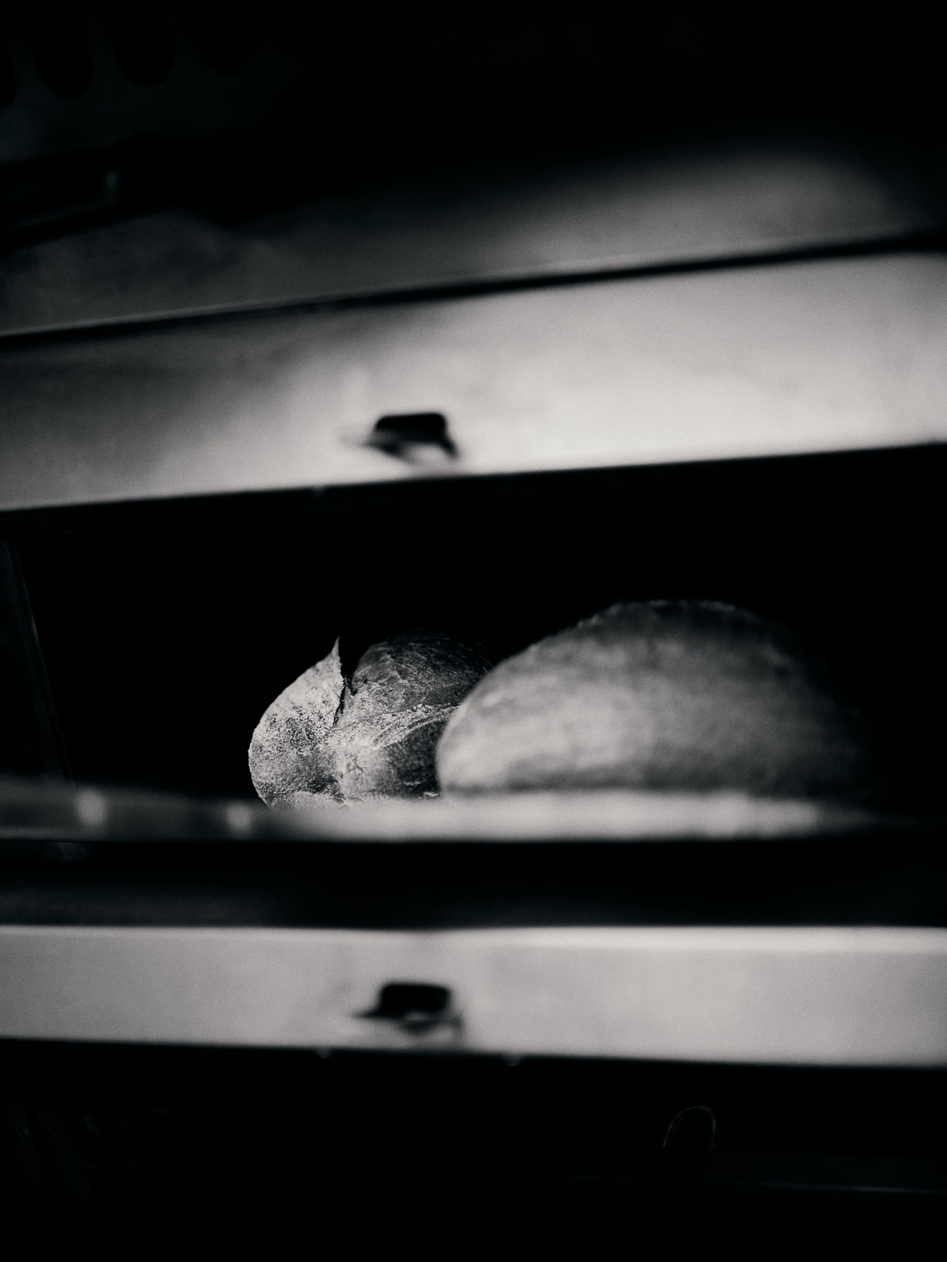 Large hearth loaves baking in a deck oven